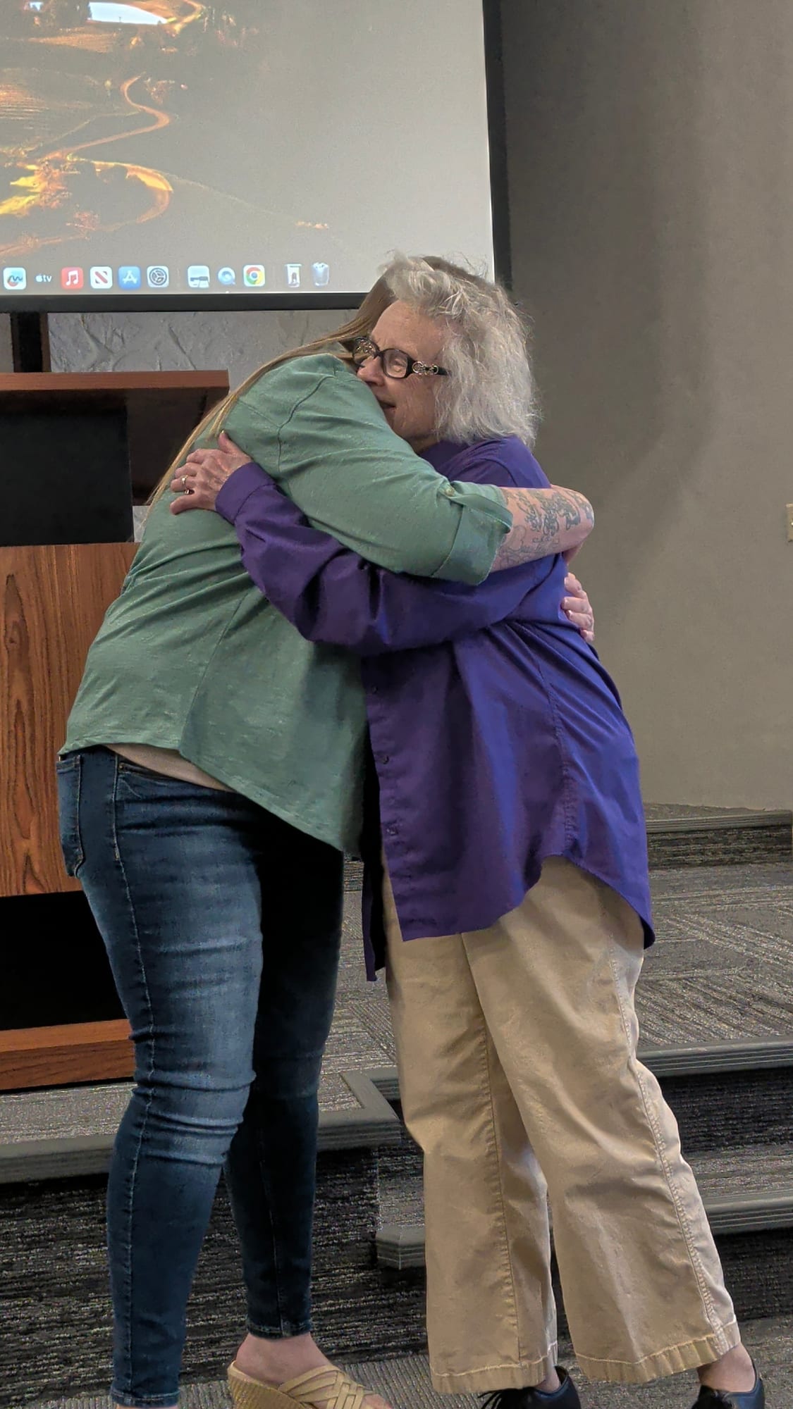 A graduate embracing the founder at her graduation ceremony.